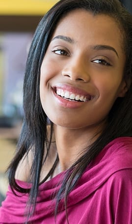 African American Female Smiling In Pink Blouse